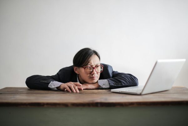 Man sitting in front of his laptop waiting